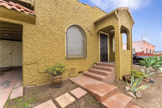 a front view of a house with outdoor seating