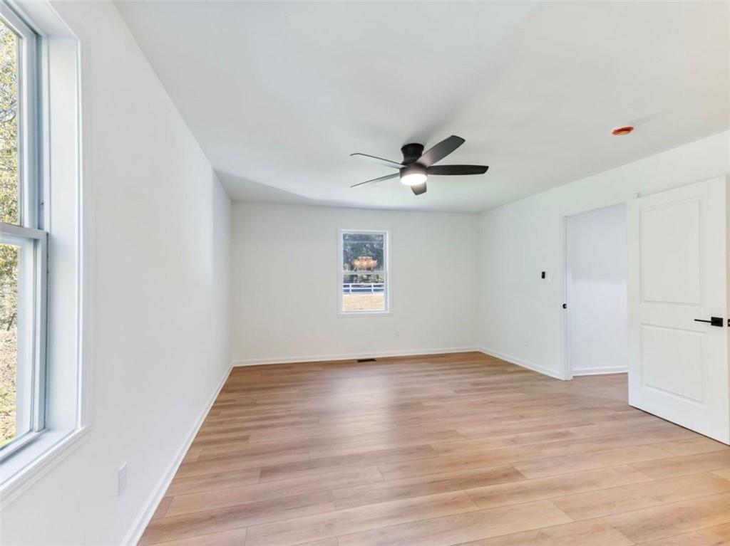 1328 Jefferson Highway Winder, GA 30680 - Photo 25 of 64 a view of empty room with wooden floor and fan