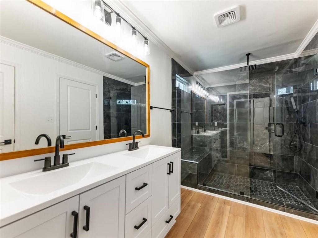 1328 Jefferson Highway Winder, GA 30680 - Photo 29 of 64 a bathroom with a shower sink and mirror