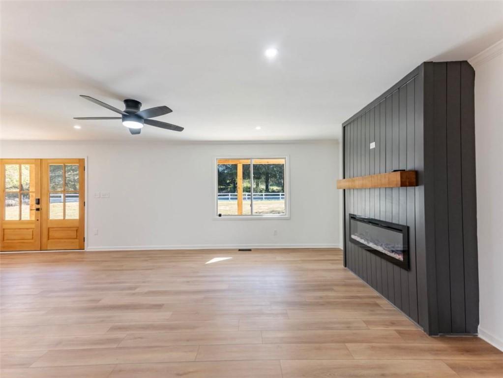 1328 Jefferson Highway Winder, GA 30680 - Photo 5 of 64 a view of an empty room with a window and wooden floor