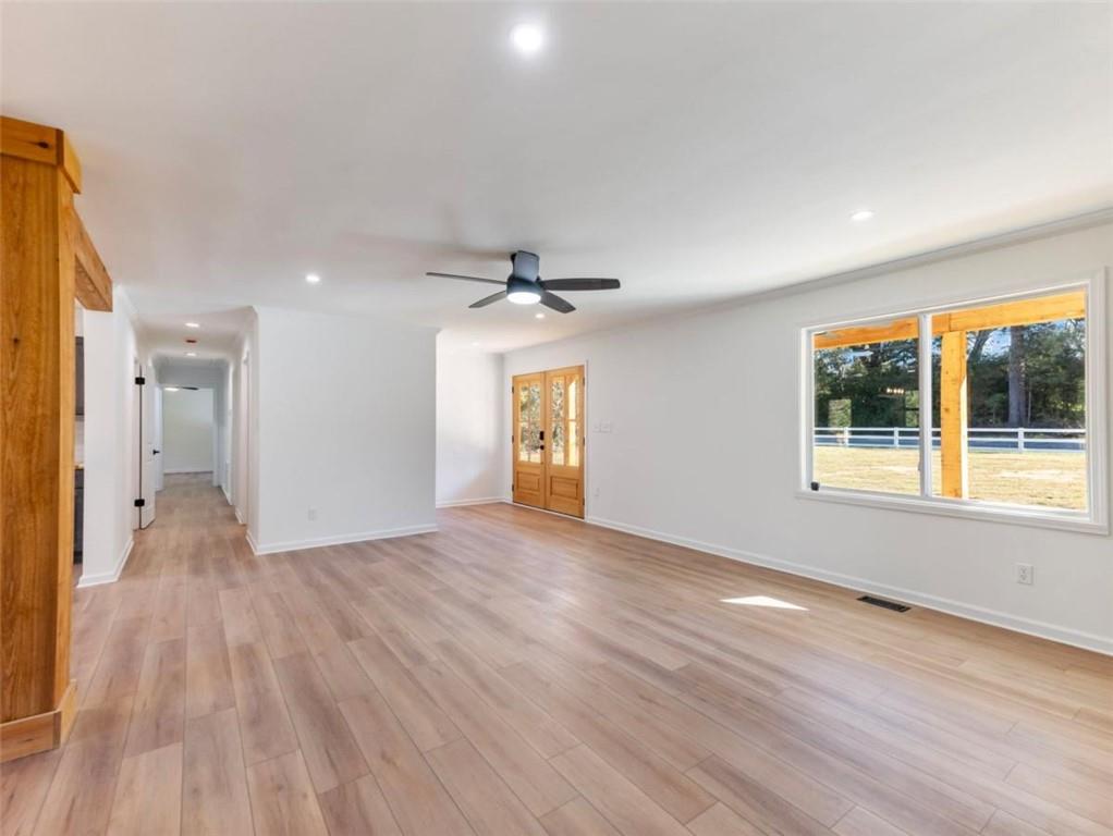 1328 Jefferson Highway Winder, GA 30680 - Photo 6 of 64 a view of an empty room with wooden floor and a window