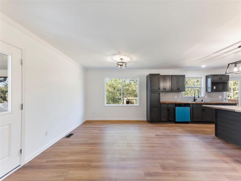 1328 Jefferson Highway Winder, GA 30680 - Photo 7 of 64 a large kitchen with kitchen island a sink wooden floor and a refrigerator