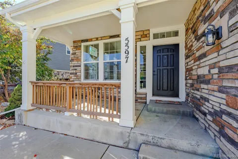 a backyard of a house with barbeque oven table and chairs