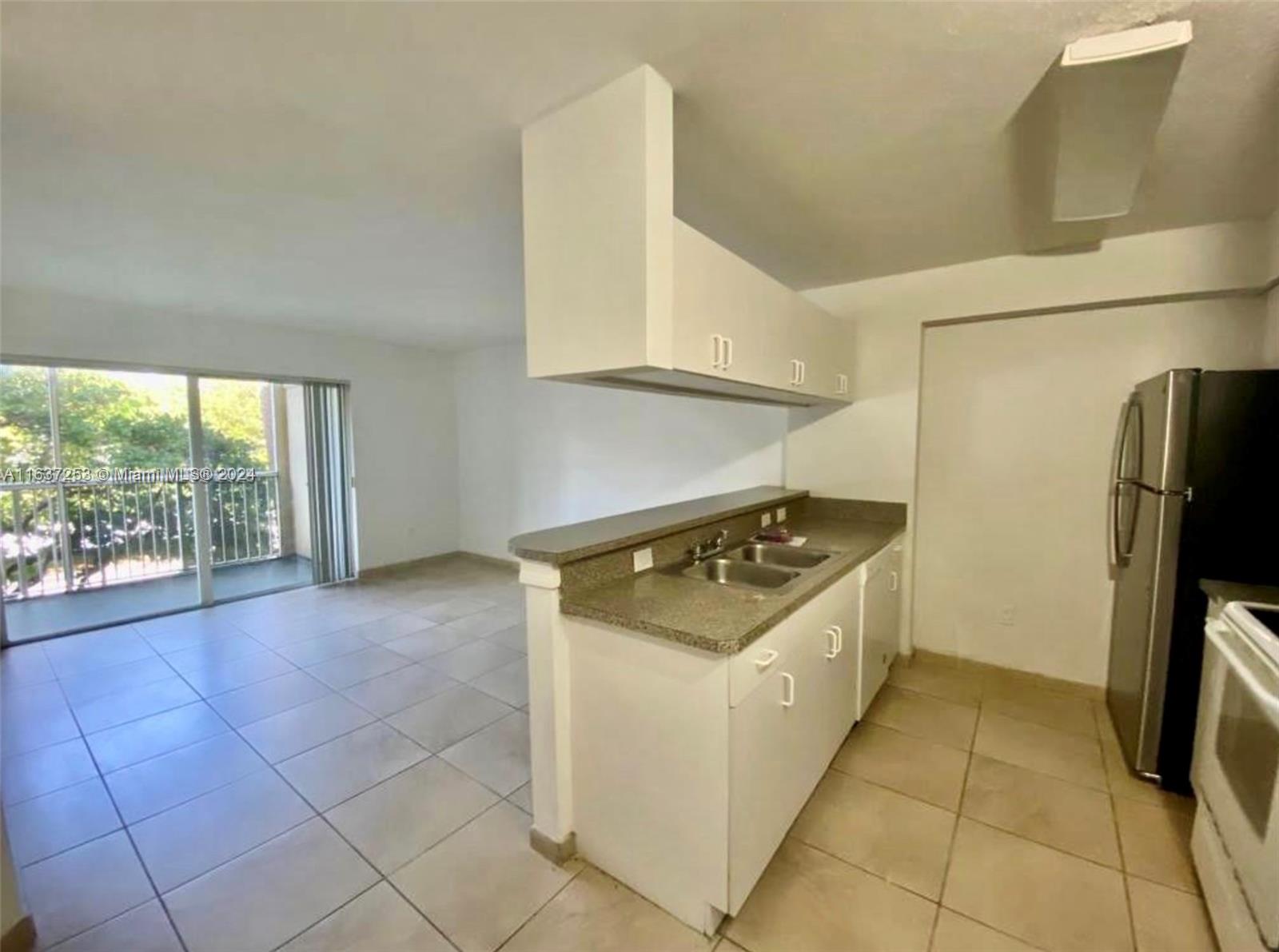 430 South Park Road, Unit 3204 Hollywood, FL 33021 - Photo 1 of 9 a kitchen with a stove a refrigerator and storage