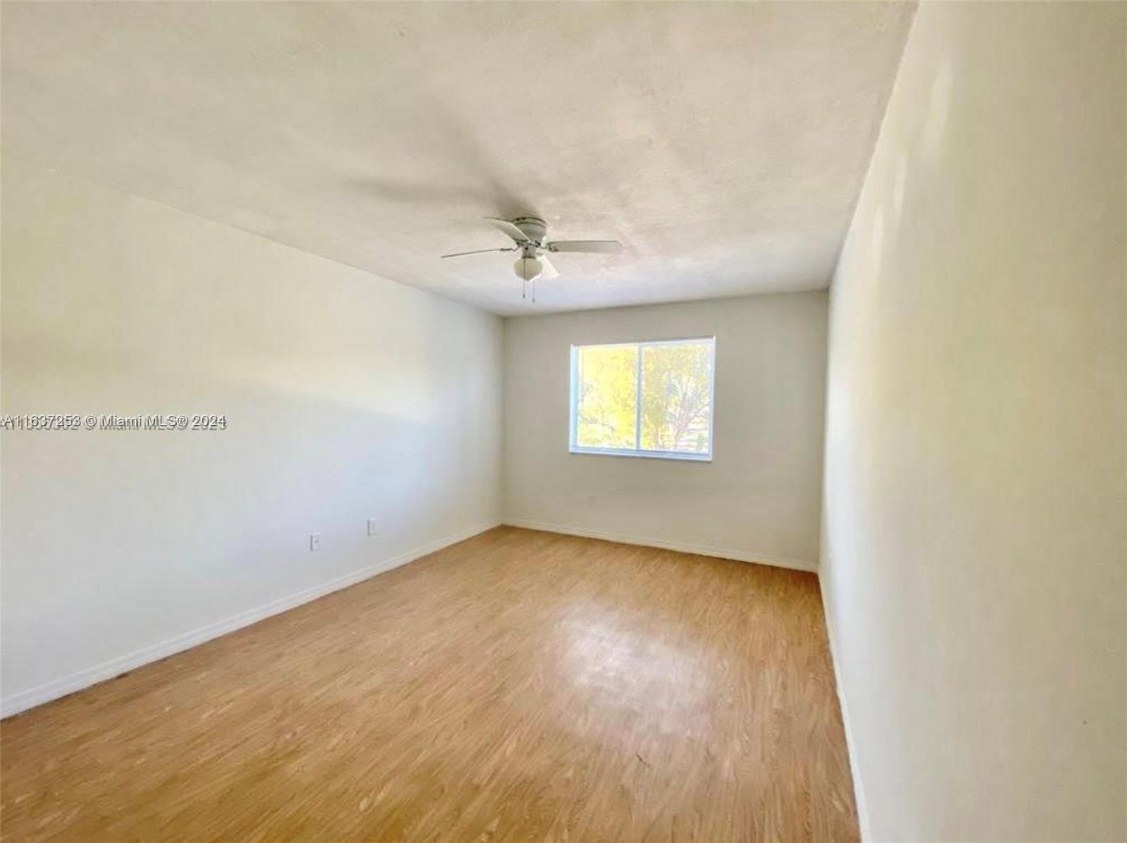 430 South Park Road, Unit 3204 Hollywood, FL 33021 - Photo 6 of 9 an empty room with a window and a ceiling fan