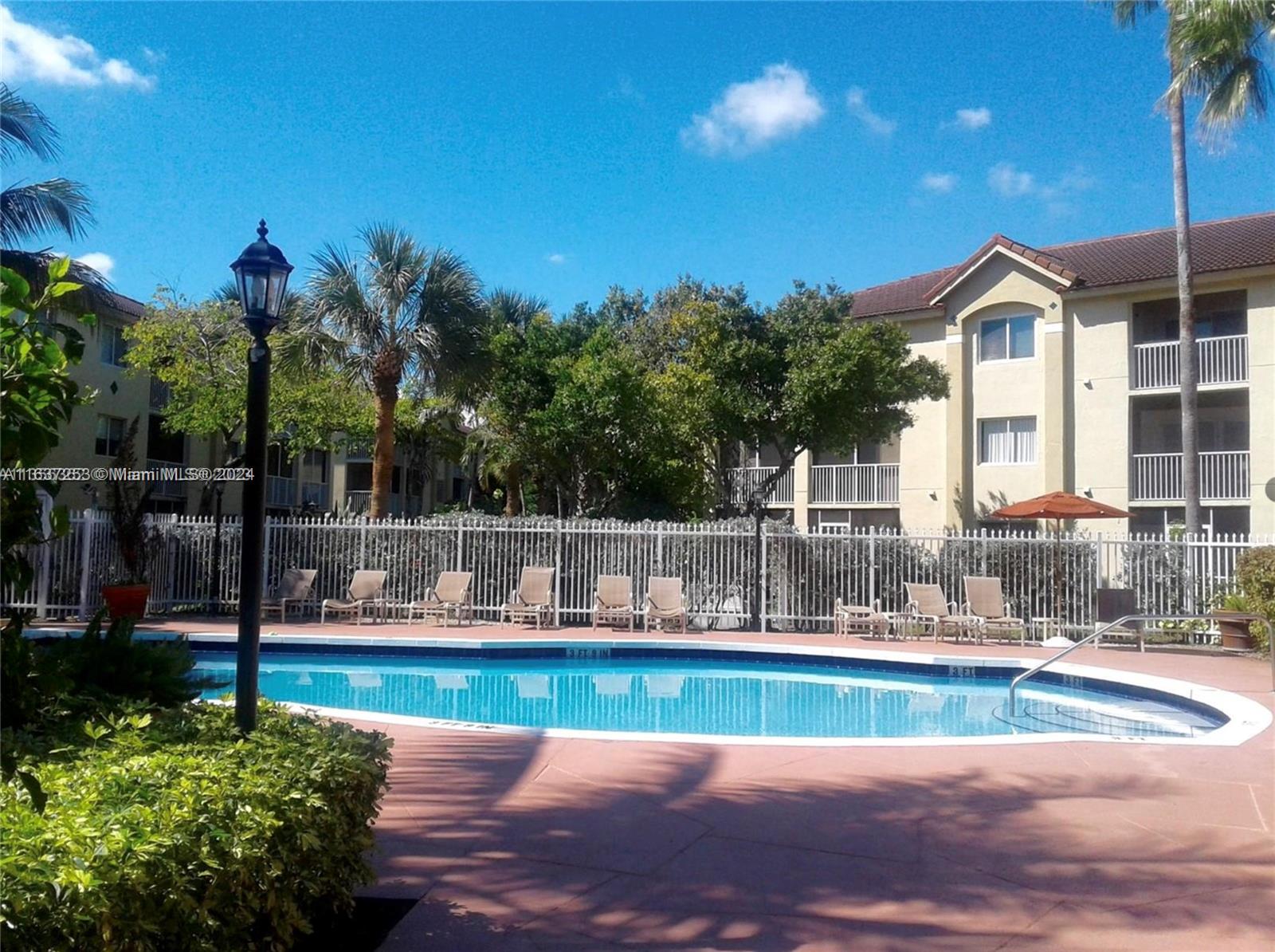 430 South Park Road, Unit 3204 Hollywood, FL 33021 - Photo 9 of 9 a view of yard with swimming pool and tall trees