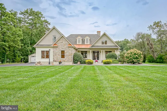 a front view of a house with a yard porch and garden