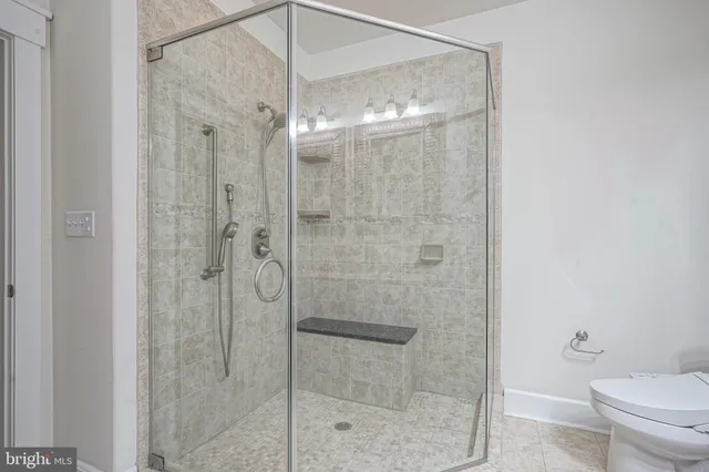 a bathroom with a shower a toilet and sink