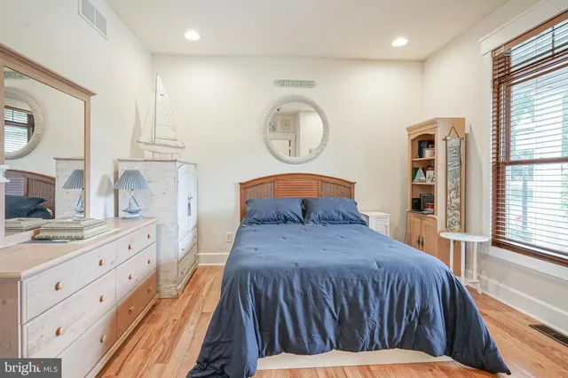 a bedroom with a large bed and a window