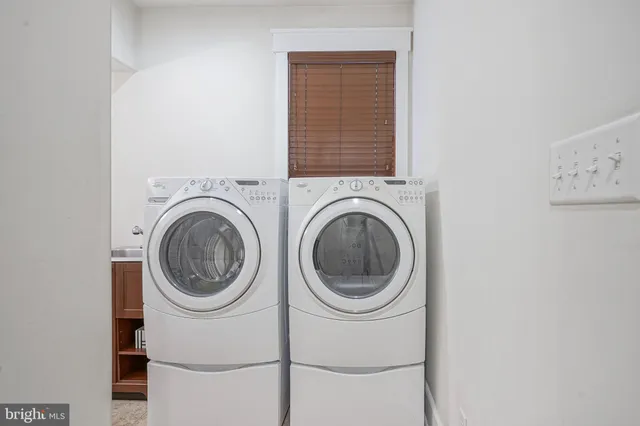 a view of a hallway with washer and dryer