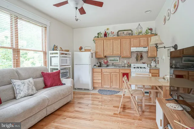 a living room with furniture and a kitchen area