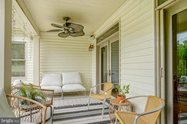 a glass door and chair sitting in front of a door
