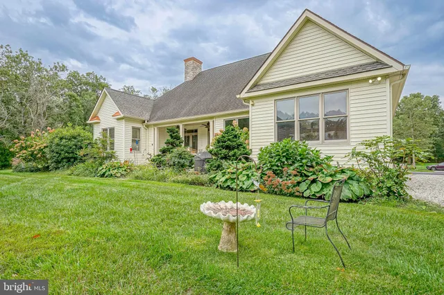 a front view of a house with a yard and porch