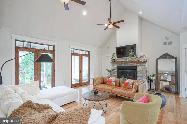 a living room with furniture a fireplace and a flat screen tv