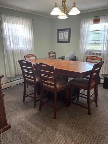a dining room with a wooden table and chairs