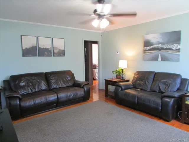 a living room with furniture and a mirror