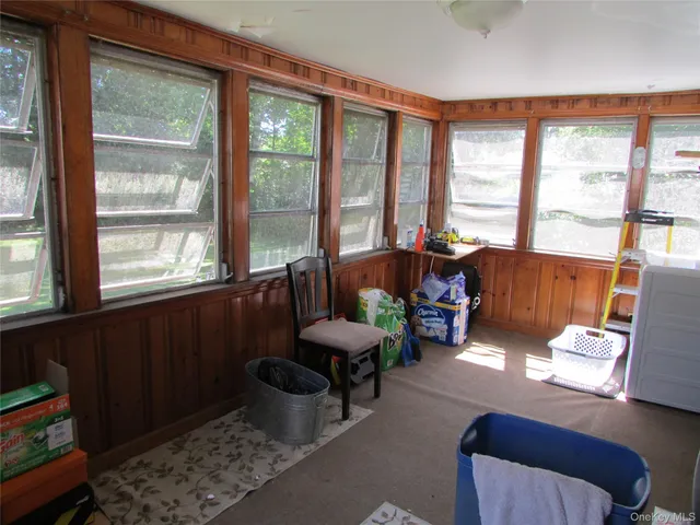 a living room with furniture and floor to ceiling windows