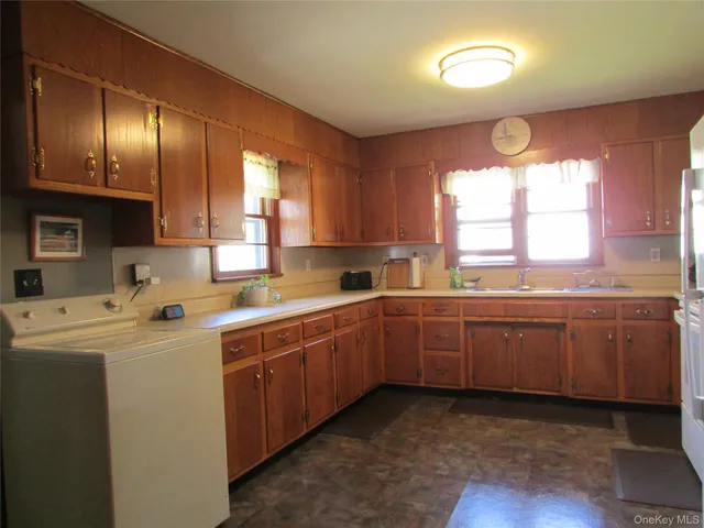 a kitchen with a sink window and cabinets