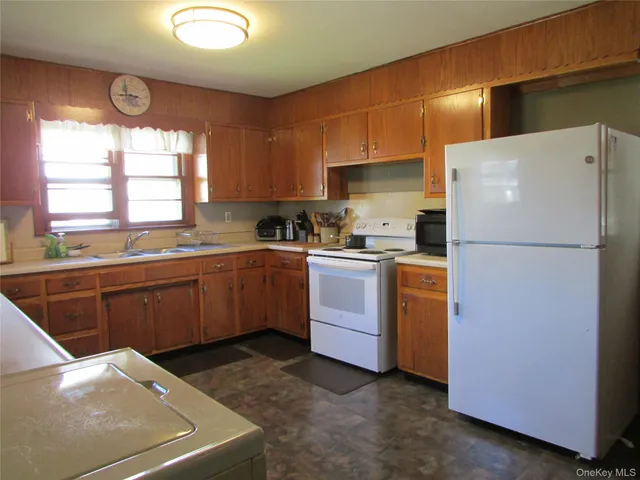 a kitchen with sink a window and stainless steel appliances