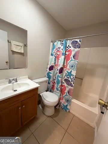 en empty room with windows and fan