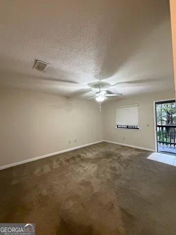a kitchen with a sink a stove top oven and white cabinets