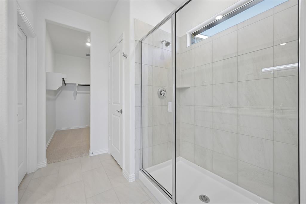 1705 Arches Road Anna, TX 75409 - Photo 23 of 33 a bathroom with a shower and a glass door