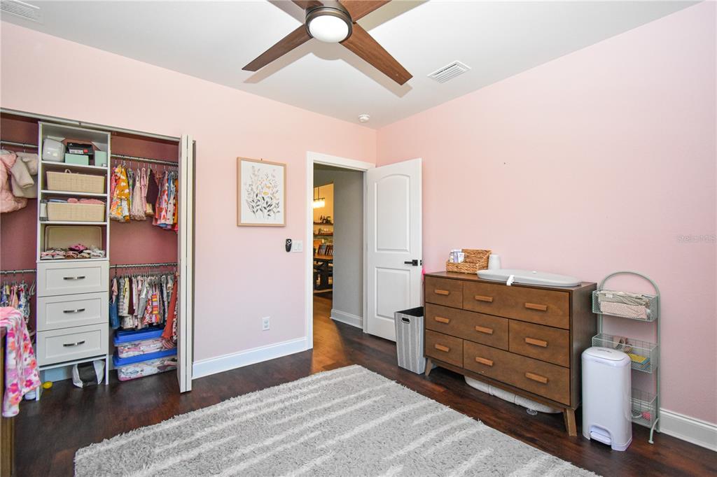 7890 Southwest 129th Avenue Cedar Key, FL 32625 - Photo 27 of 45 a bedroom with a dresser and a chandelier