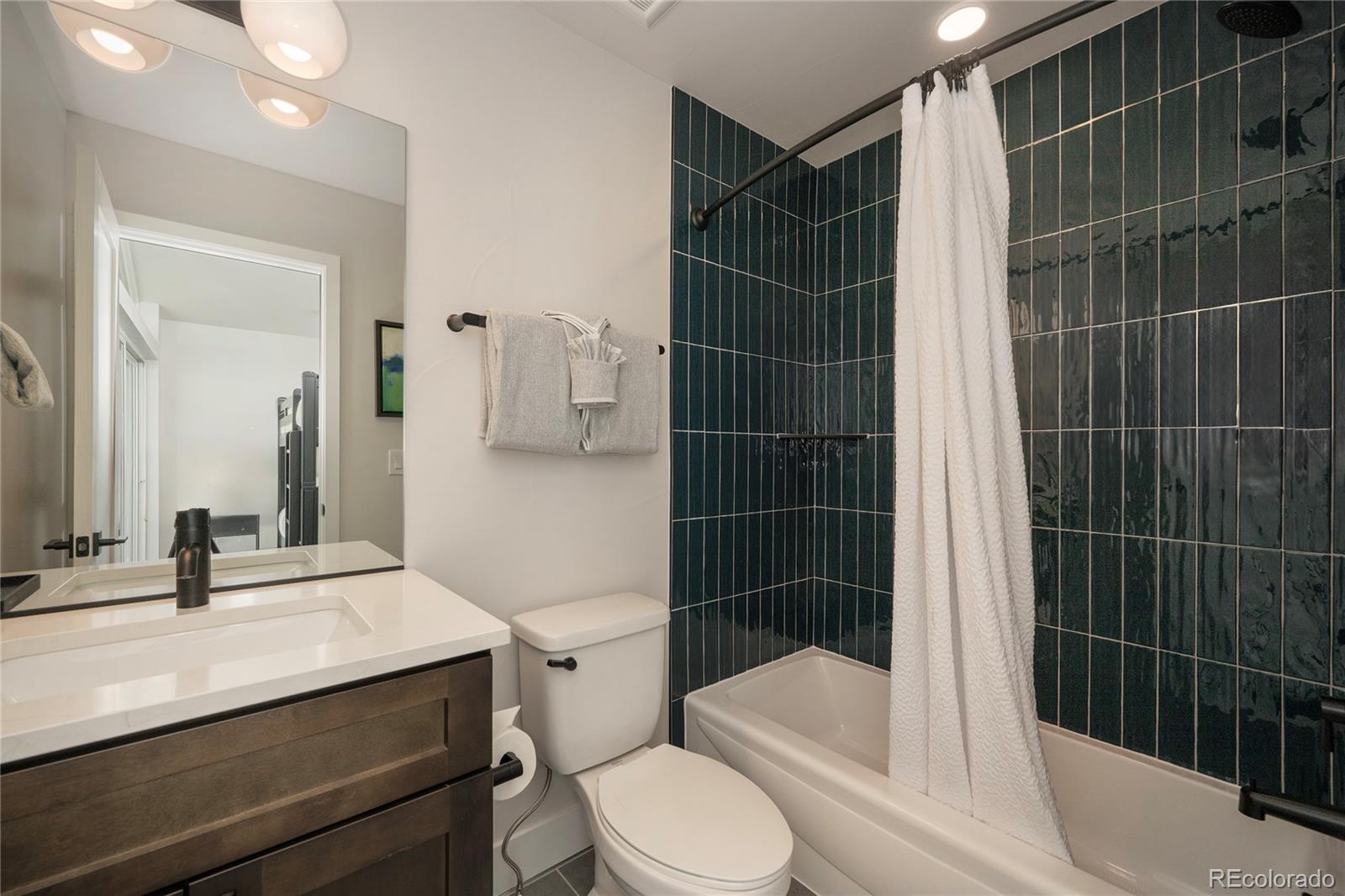 34 Wheeler Road Winter Park, CO 80482 - Photo 32 of 50 a bathroom with a sink toilet vanity and shower
