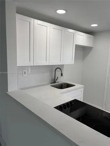 a kitchen with a sink and cabinets