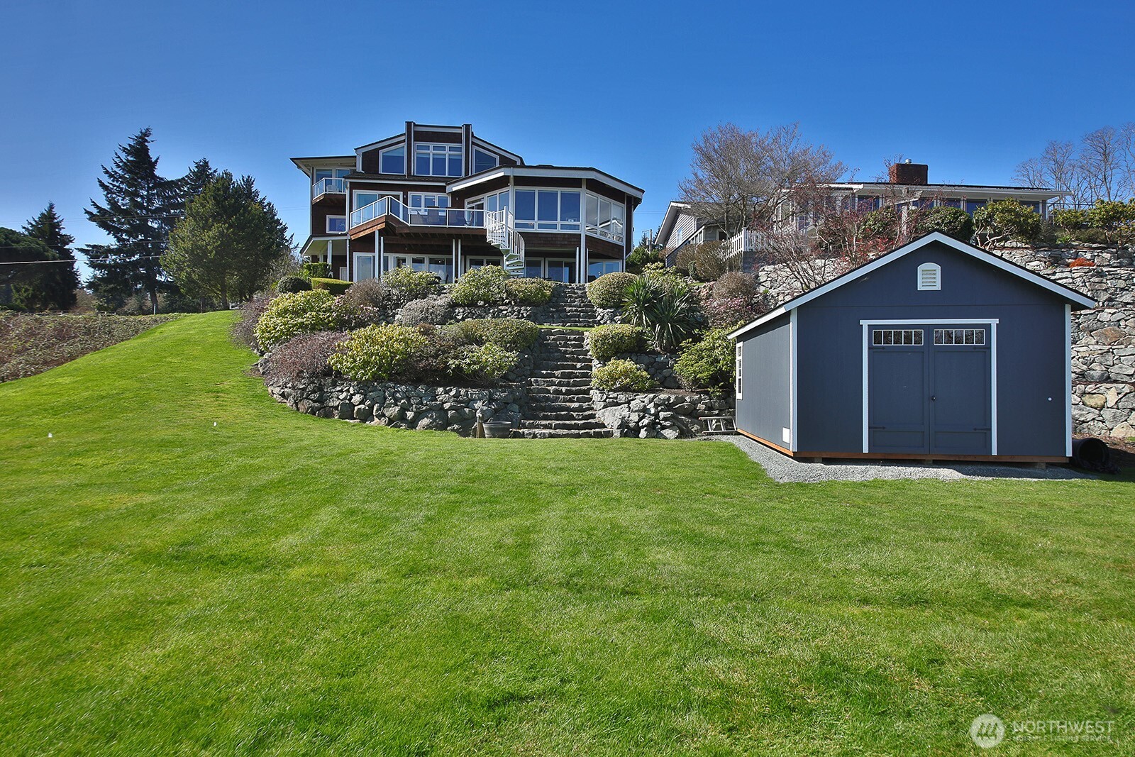 6595 Anderson Road Clinton, WA 98236 - Photo 12 of 40 a front view of a house with a garden