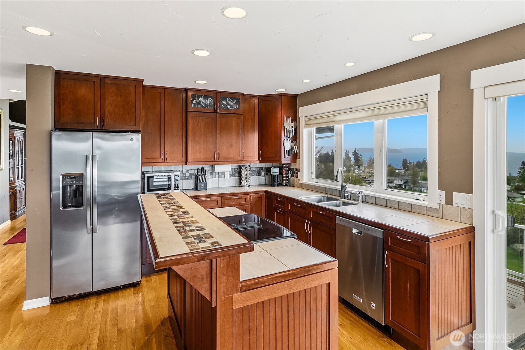 6595 Anderson Road Clinton, WA 98236 - Photo 21 of 40 a kitchen with stainless steel appliances granite countertop a sink a stove and a refrigerator
