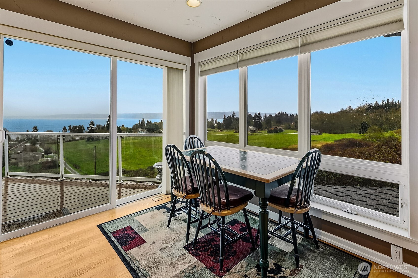 6595 Anderson Road Clinton, WA 98236 - Photo 23 of 40 a view of a city from a dining room with furniture and window