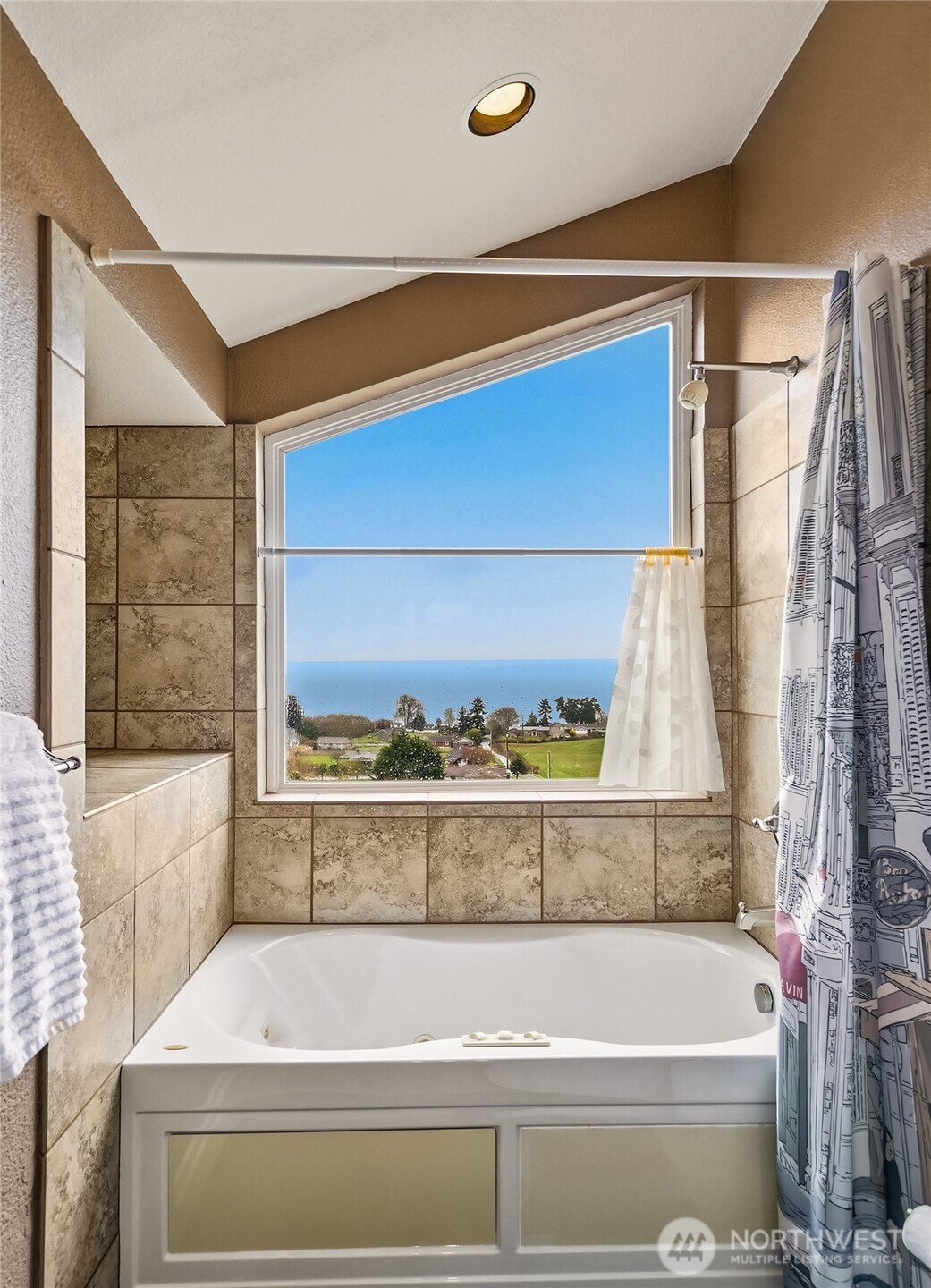 6595 Anderson Road Clinton, WA 98236 - Photo 28 of 40 a bathroom with a bathtub and a window