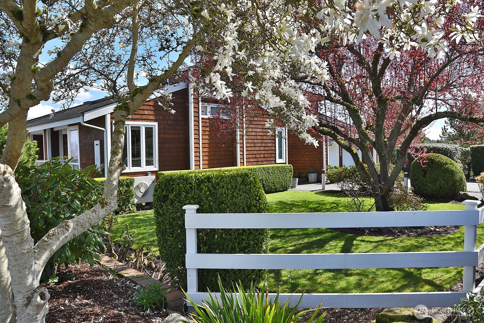 6595 Anderson Road Clinton, WA 98236 - Photo 3 of 40 a front view of a house with a garden