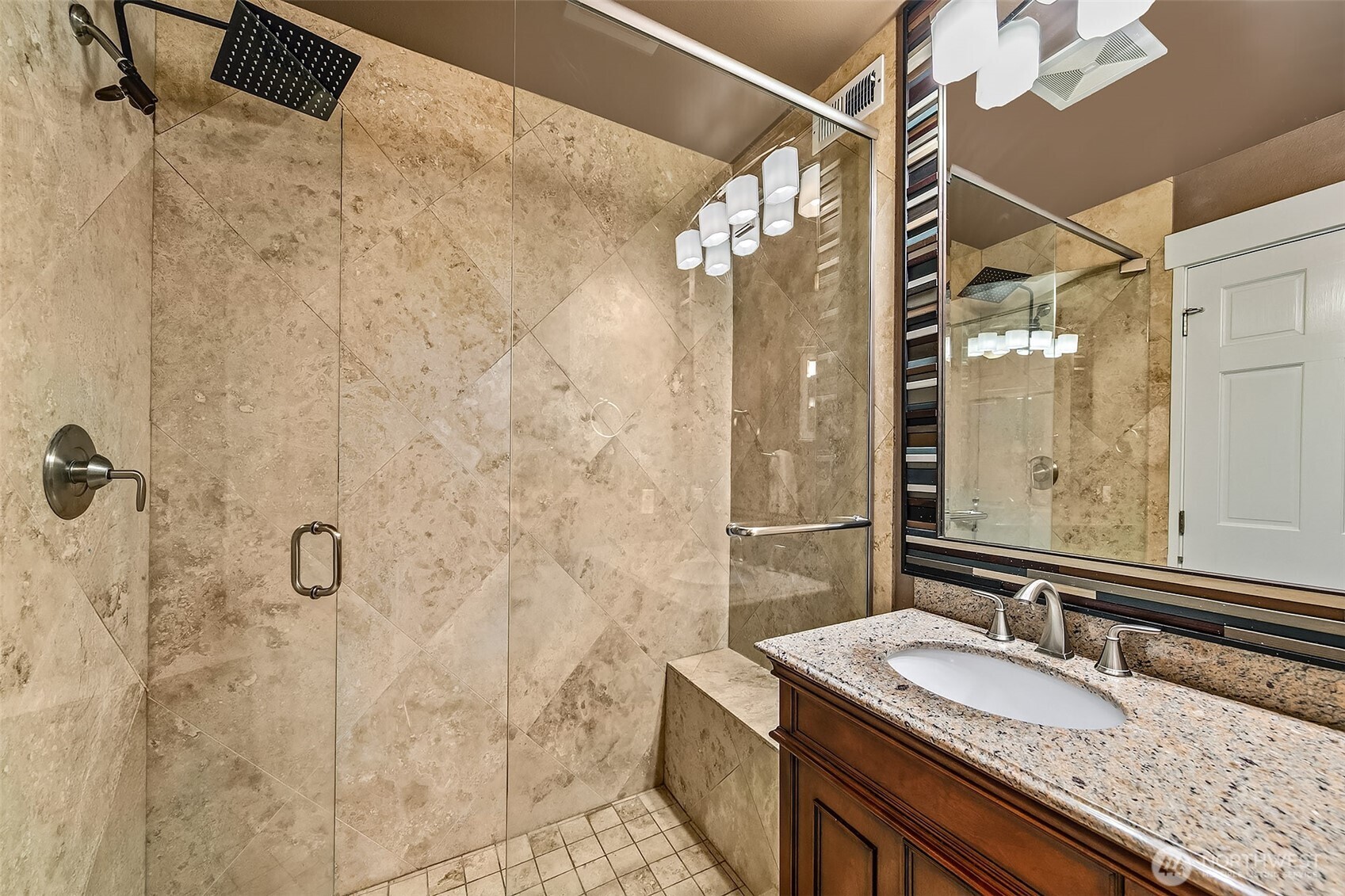6595 Anderson Road Clinton, WA 98236 - Photo 32 of 40 a bathroom with a granite countertop shower a sink and vanity