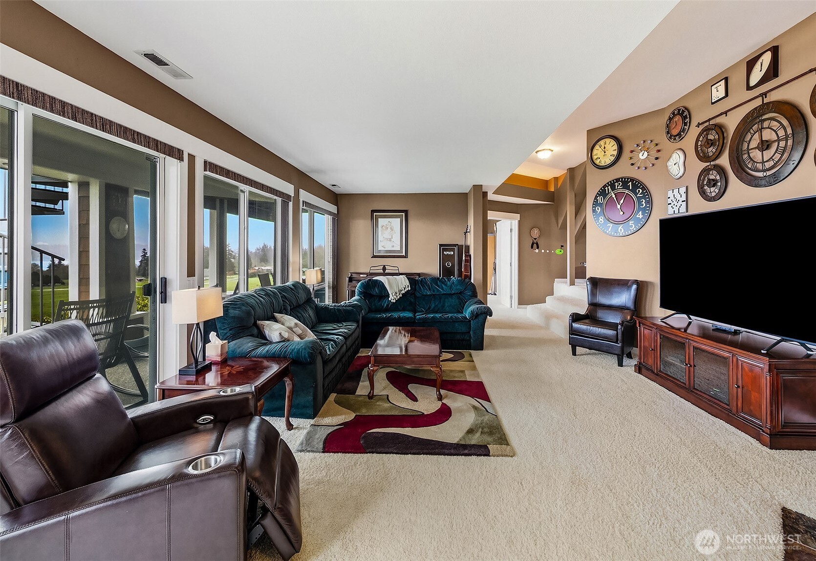 6595 Anderson Road Clinton, WA 98236 - Photo 33 of 40 a living room with furniture a flat screen tv and a window