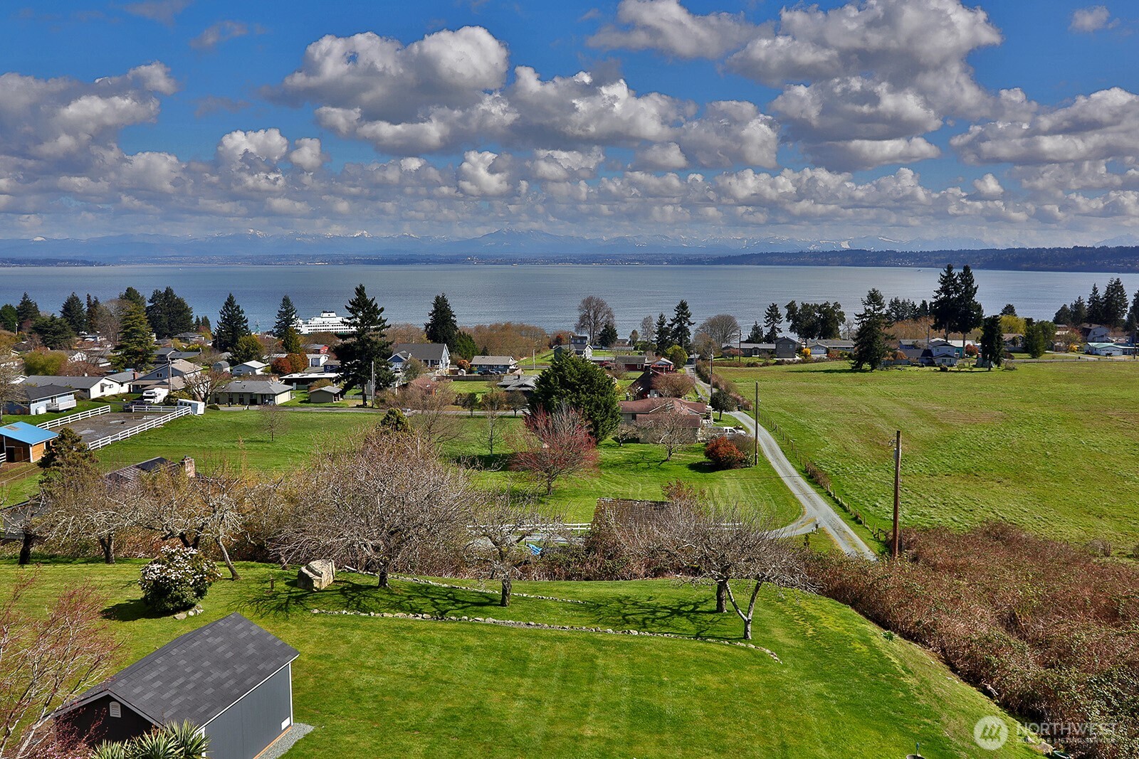 6595 Anderson Road Clinton, WA 98236 - Photo 36 of 40 an aerial view of a house with a yard and lake view