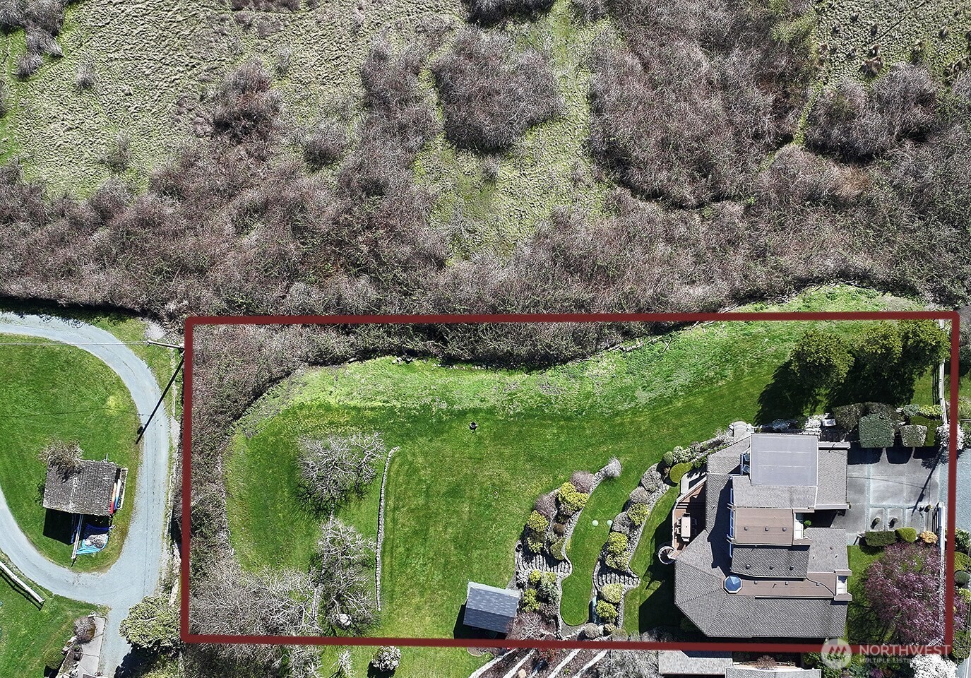 6595 Anderson Road Clinton, WA 98236 - Photo 37 of 40 an aerial view of a house with a yard and green space