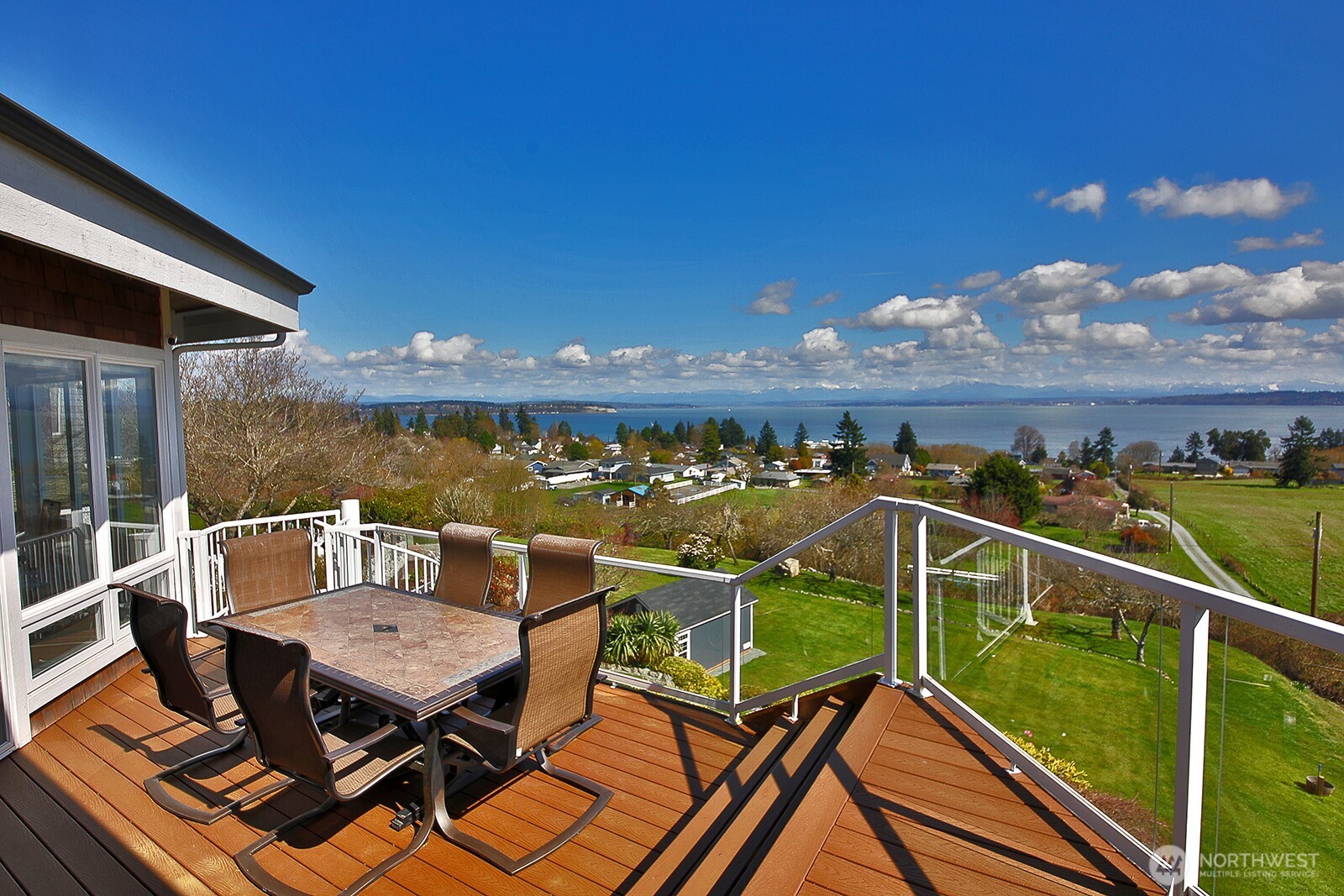 6595 Anderson Road Clinton, WA 98236 - Photo 5 of 40 a view of a balcony with two chairs and a table
