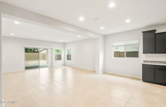 a large kitchen with stainless steel appliances kitchen island granite countertop a large counter top and a stove