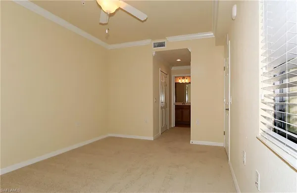 a view of a small space with wooden floor and a window