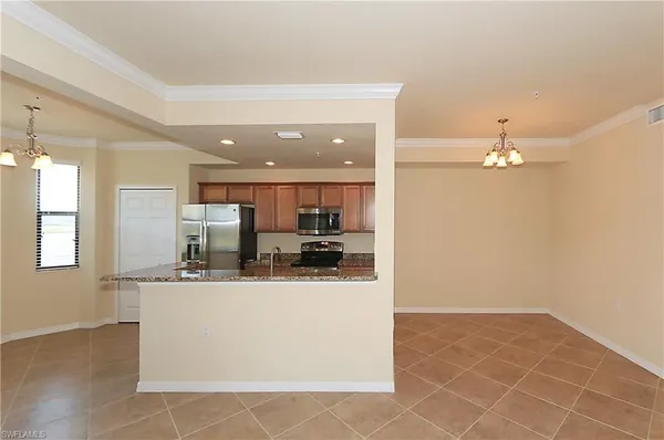 a kitchen with stainless steel appliances a sink and a refrigerator