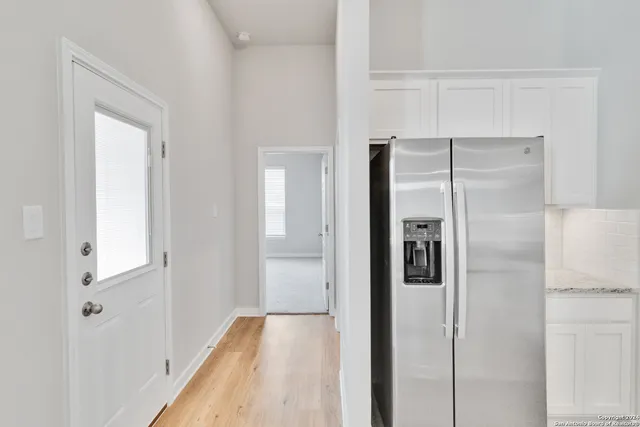 a view of hallway with wooden floor