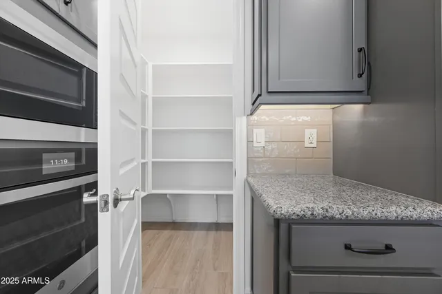a kitchen with granite countertop cabinets and oven