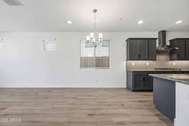 a kitchen with stainless steel appliances granite countertop a sink dishwasher a stove and a large window