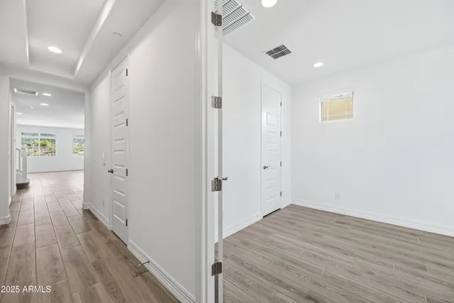 a view of a hallway with wooden floor