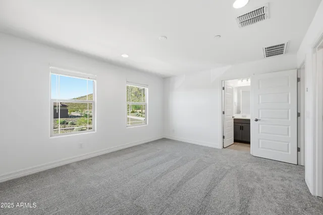 an empty room with windows and closet