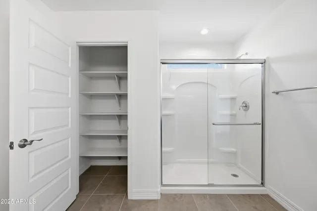 a bathroom with a glass shower door