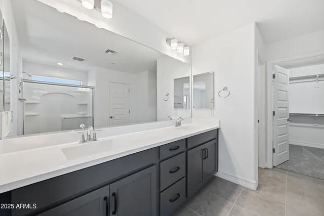 a bathroom with a double vanity sink mirror and toilet