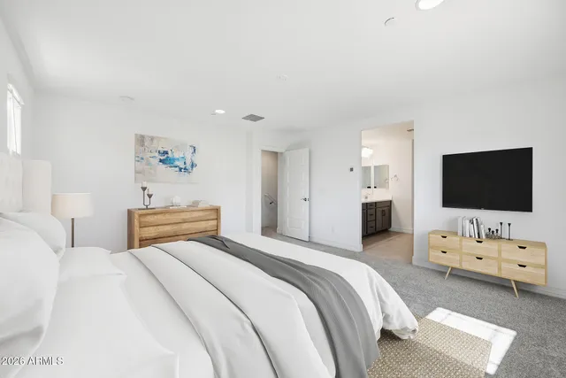 a bedroom with a bed and a flat screen tv